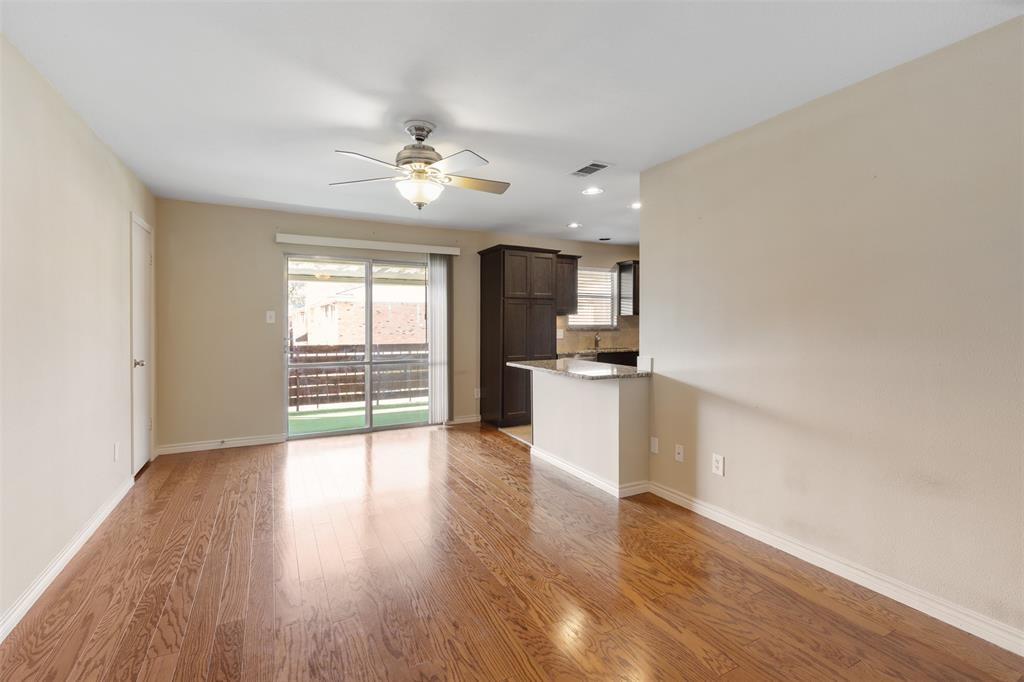 4709 Skillman Street, Unit D Dallas, TX 75206 - Photo 13 of 28 a view of an empty room with a window and wooden floor