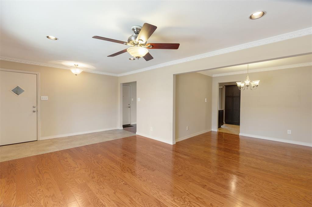 4709 Skillman Street, Unit D Dallas, TX 75206 - Photo 3 of 28 a view of an empty room with wooden floor and a ceiling fan