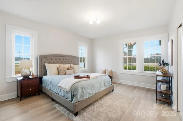 a bedroom with a bed and a couch next to a window