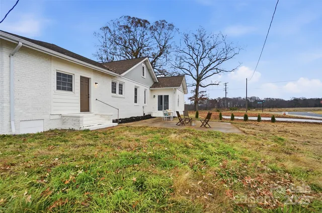 a view of a house with a yard and covered with snow