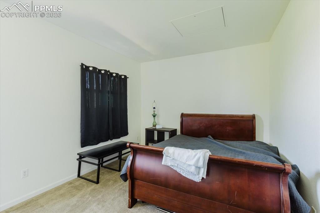 5800 Tower Road, Unit 108 Denver, CO 80249 - Photo 11 of 34 Carpeted room featuring a window with dark curtains, white walls, and a ceiling access panel