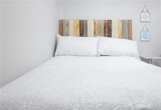 a large white bed in a room