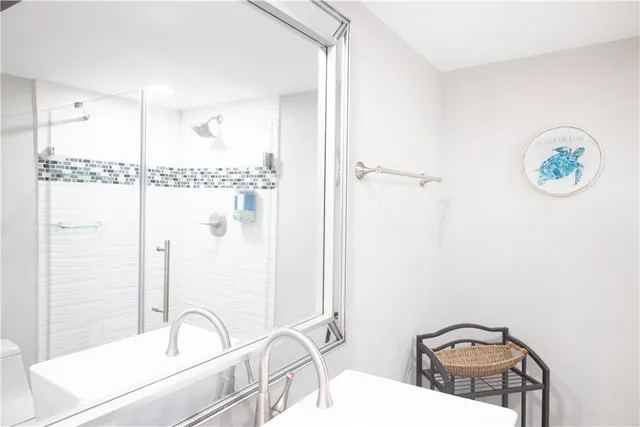 a bathroom with a sink a toilet and a shower