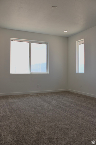 2613 Scarlet Road, Unit 258 Eagle Mountain, UT 84005 - Photo 14 of 32 Expansive room featuring multiple windows, recessed ceiling lighting, textured wall finishes, and clean baseboard trim