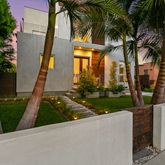 a view of a palm trees front of house