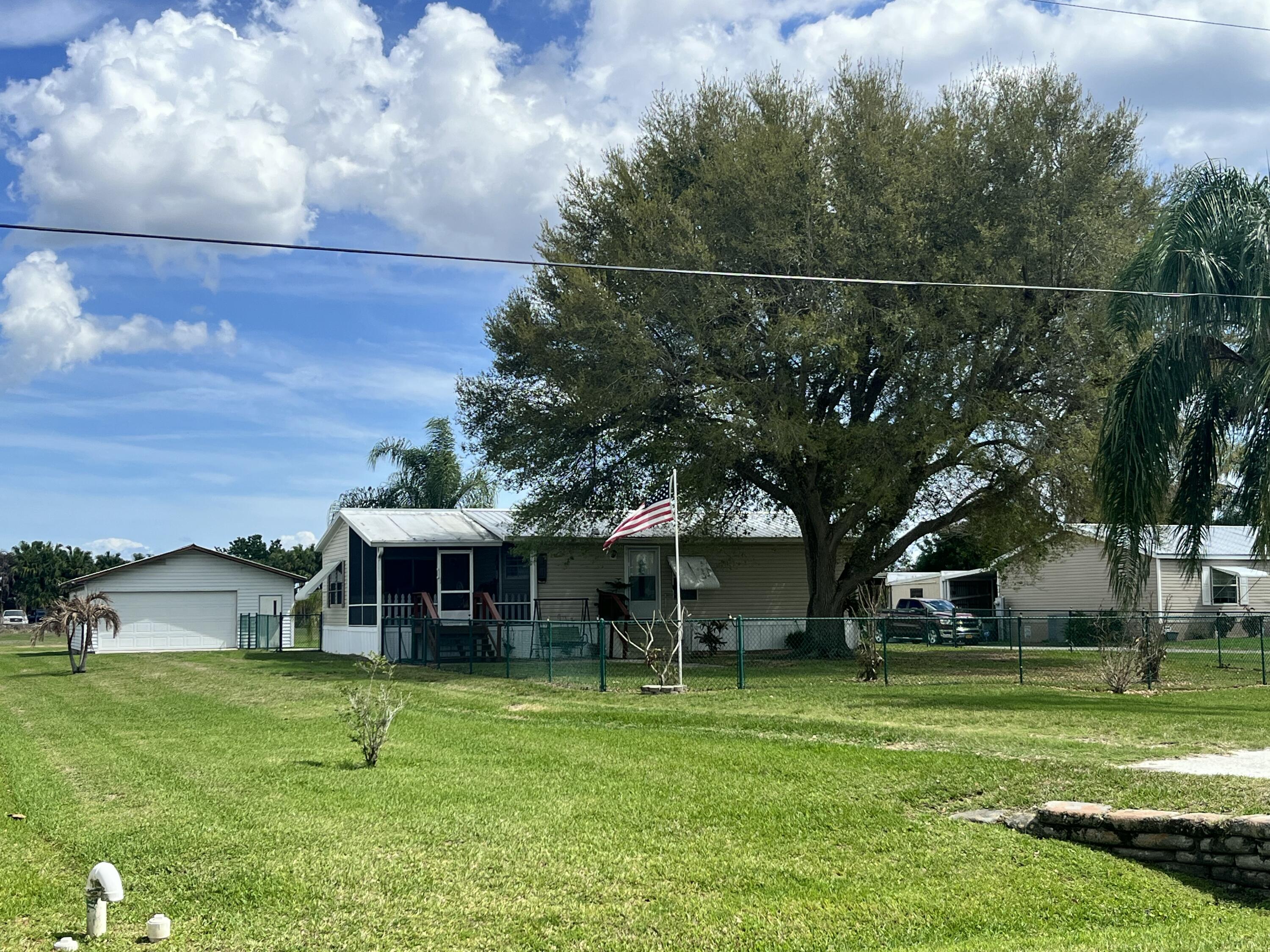 4064 Southwest 9th Way Okeechobee, FL 34974 - Photo 1 of 39 a view of a house with a yard balcony and sitting area
