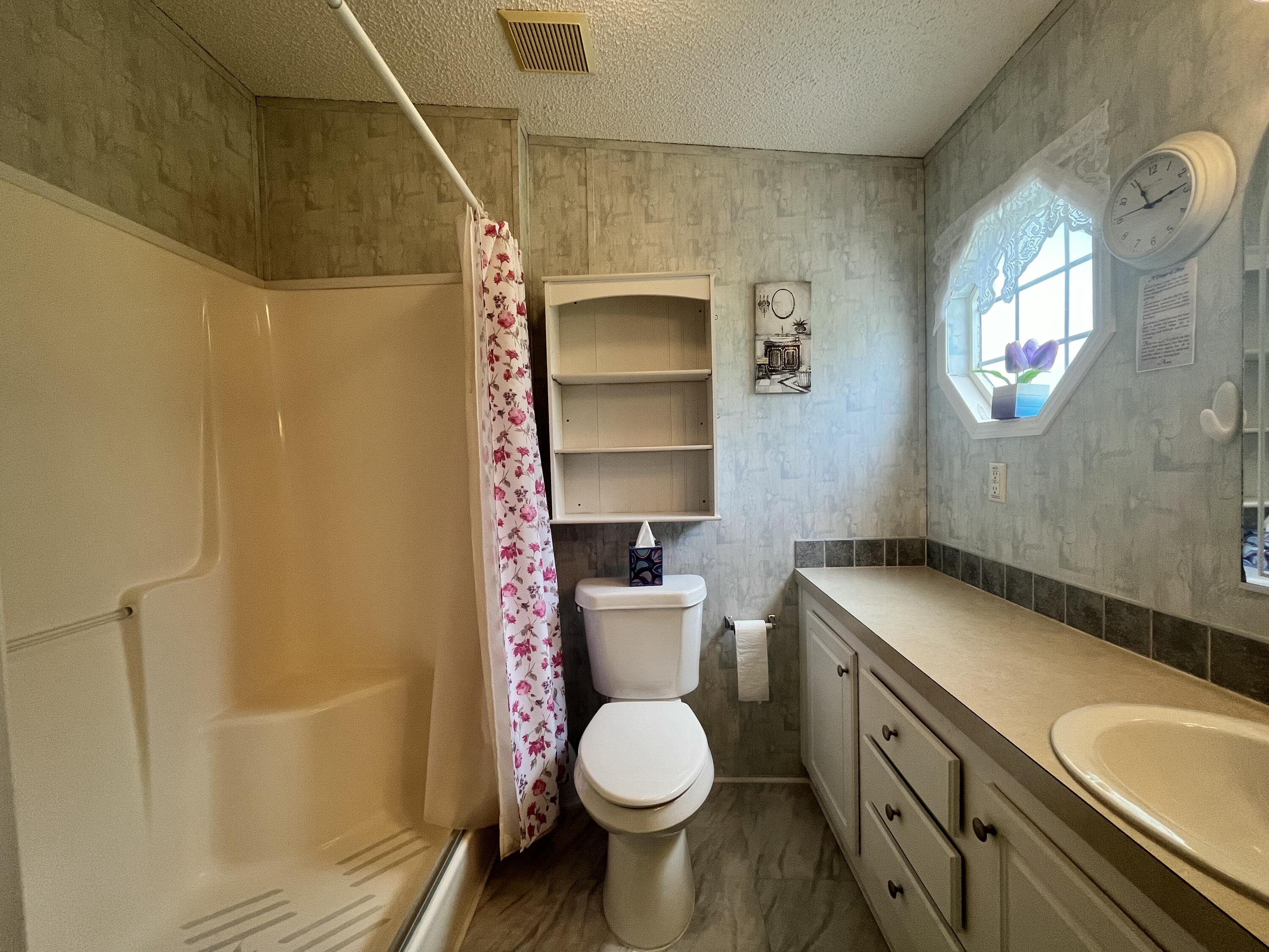 4064 Southwest 9th Way Okeechobee, FL 34974 - Photo 14 of 39 a bathroom with a sink toilet and shower