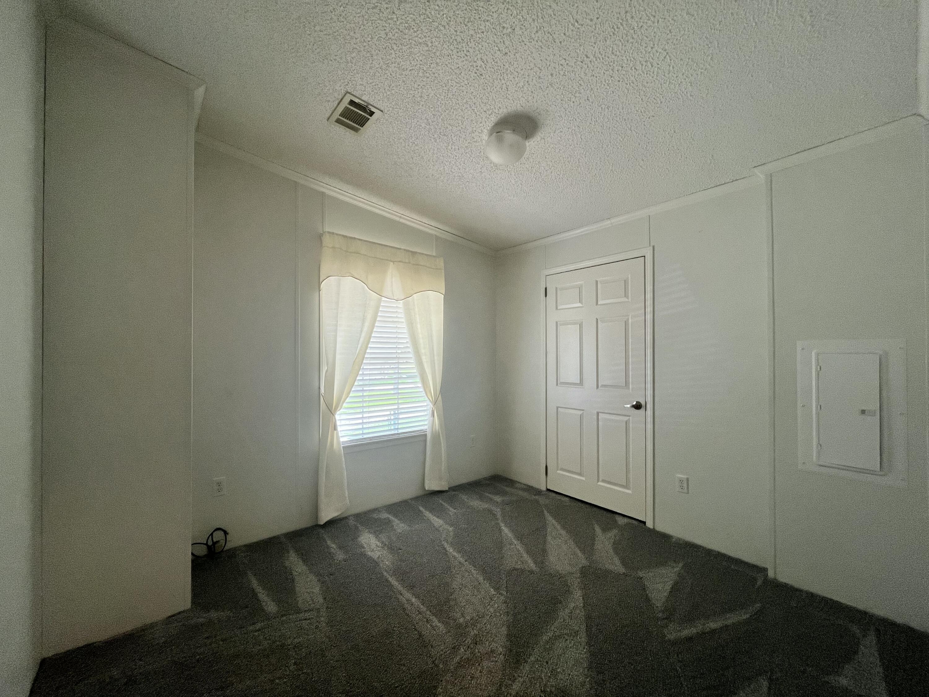 4064 Southwest 9th Way Okeechobee, FL 34974 - Photo 15 of 39 a view of an empty room and window