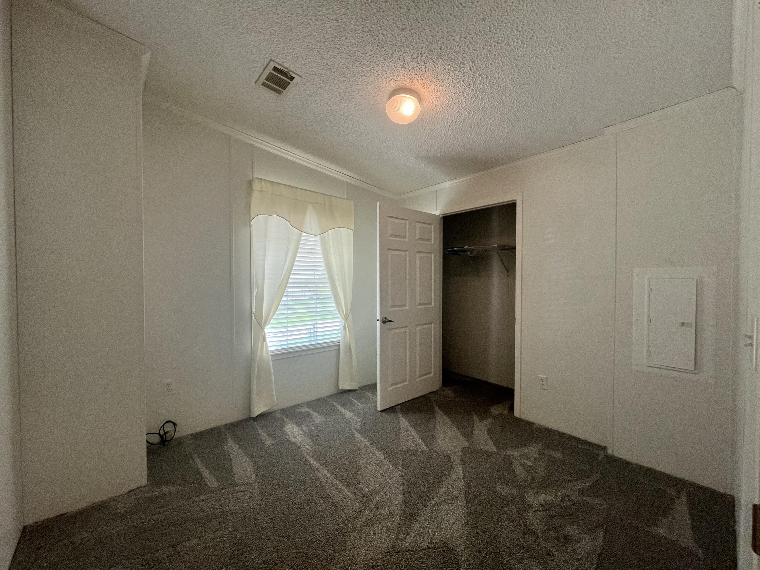 4064 Southwest 9th Way Okeechobee, FL 34974 - Photo 16 of 39 an empty room with windows