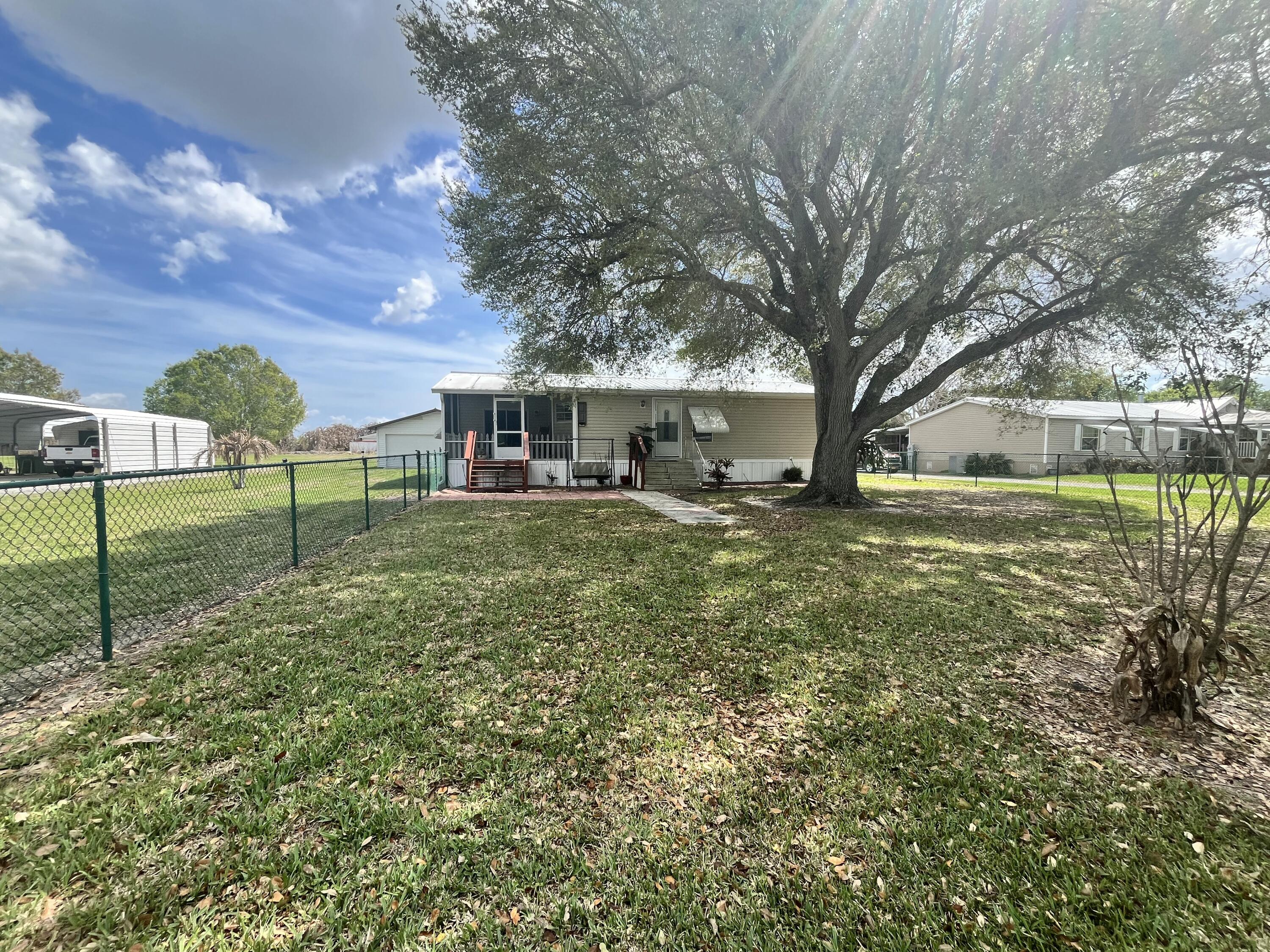 4064 Southwest 9th Way Okeechobee, FL 34974 - Photo 20 of 39 a view of a house with a yard