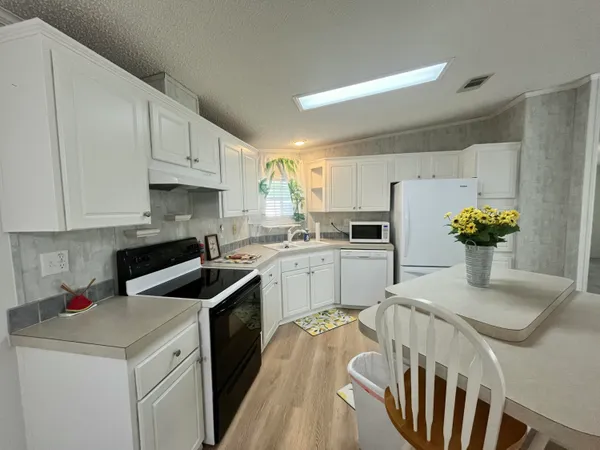 a kitchen that has a sink and cabinets