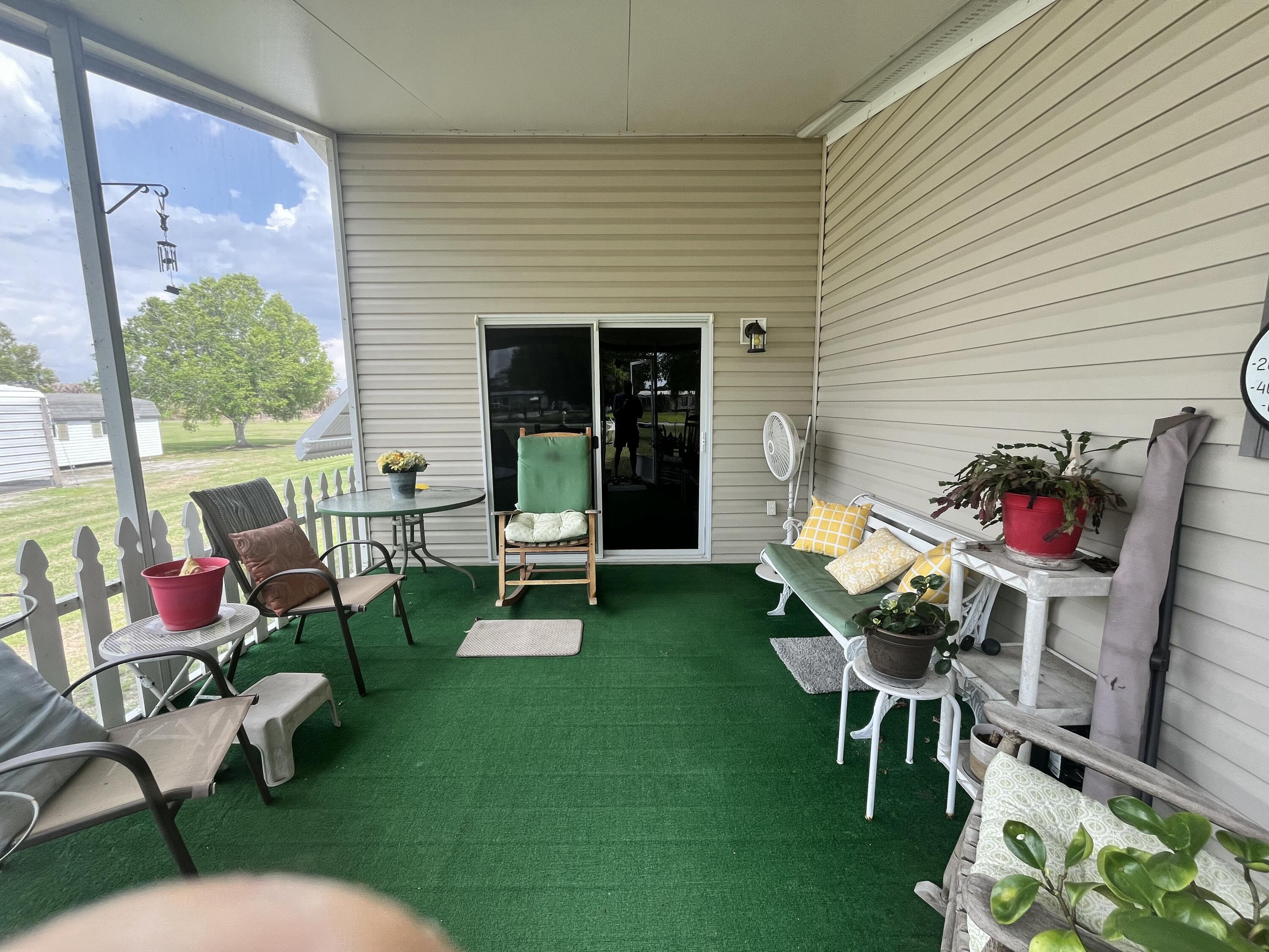 4064 Southwest 9th Way Okeechobee, FL 34974 - Photo 22 of 39 a building outdoor space with furniture and garden