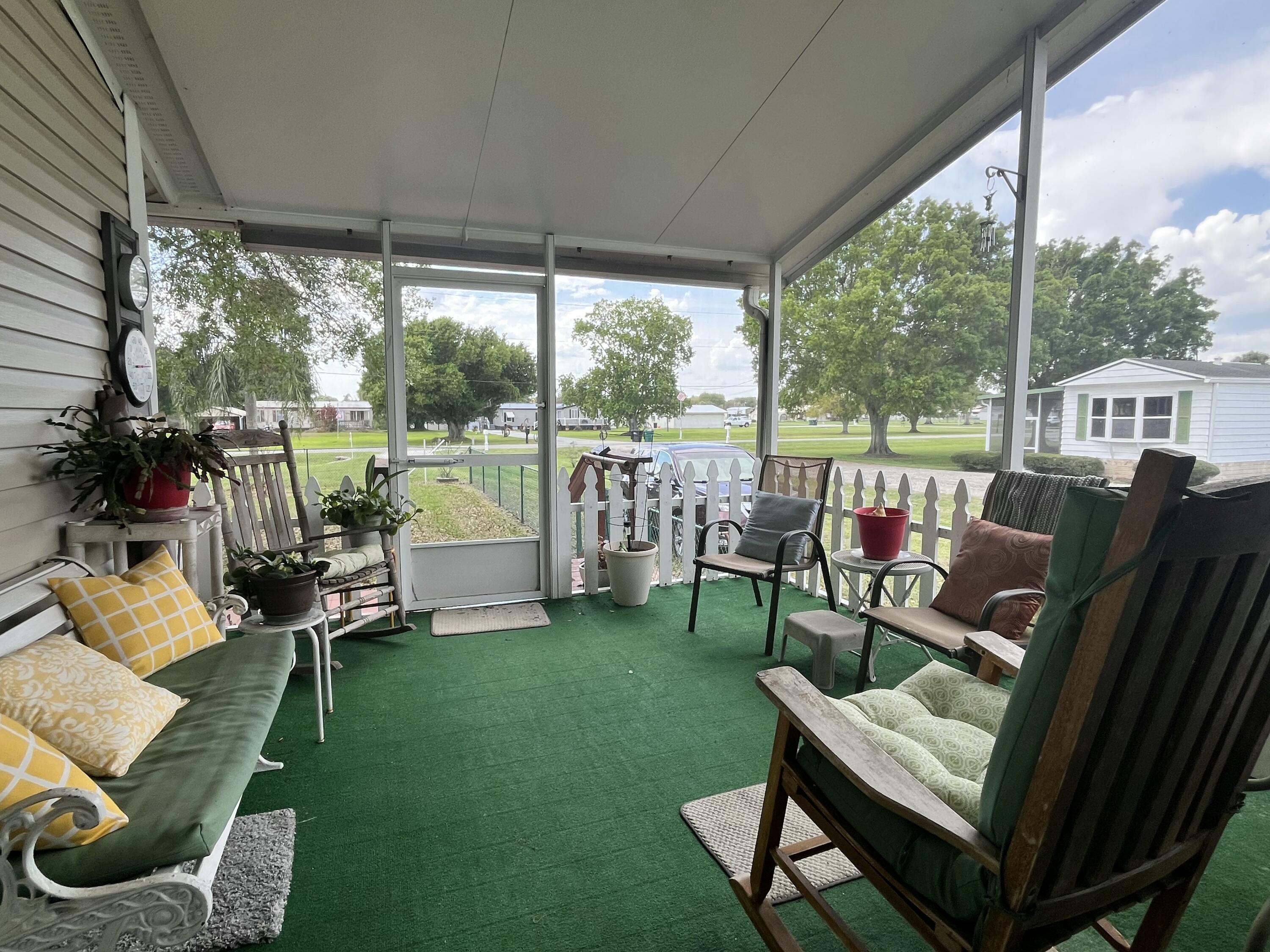 4064 Southwest 9th Way Okeechobee, FL 34974 - Photo 23 of 39 a view of a patio with couches chairs and a yard