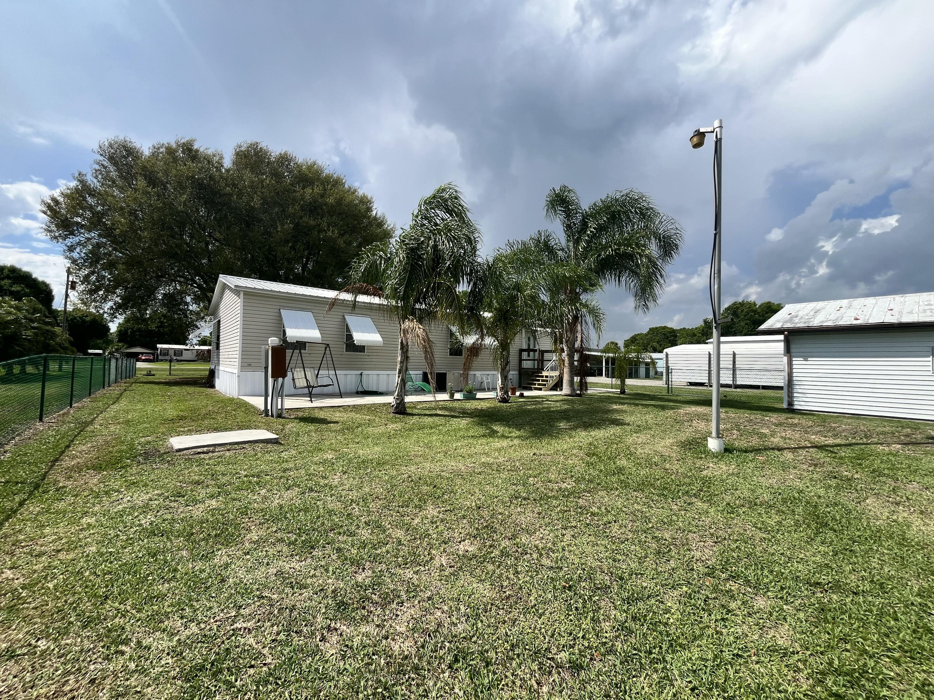 4064 Southwest 9th Way Okeechobee, FL 34974 - Photo 26 of 39 a view of a house with a yard and sitting area