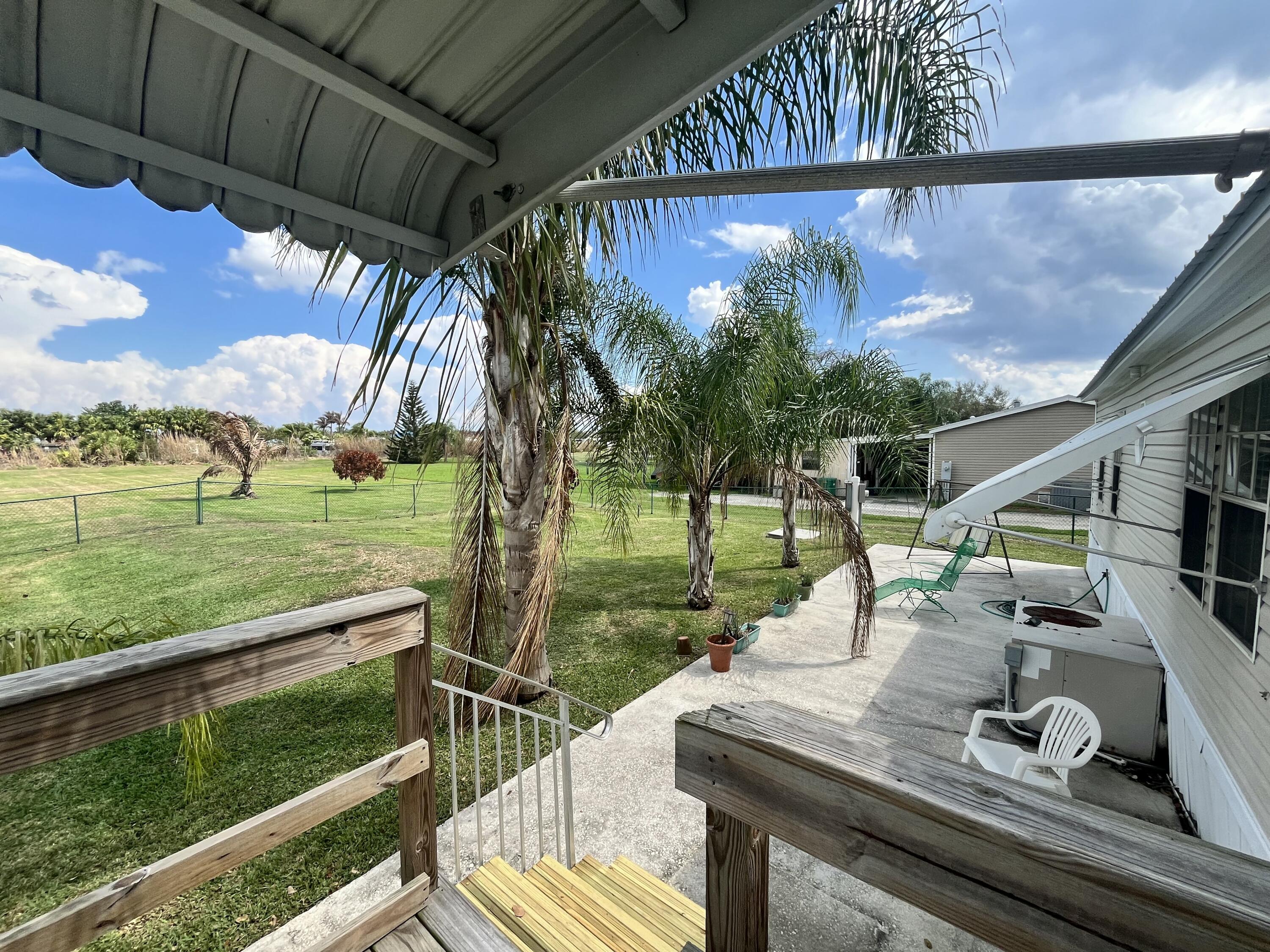 4064 Southwest 9th Way Okeechobee, FL 34974 - Photo 29 of 39 a view of a porch with furniture and garden