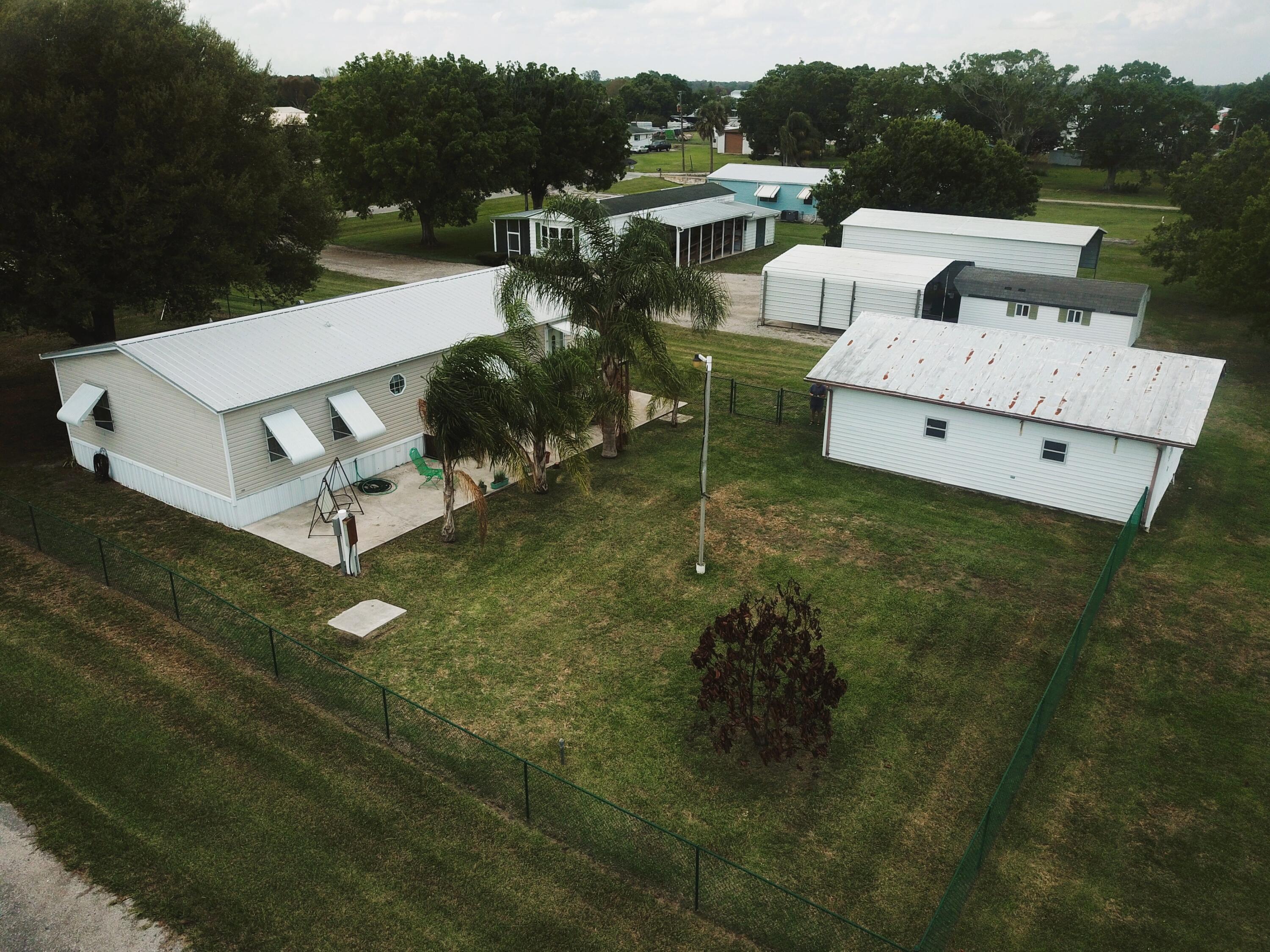 4064 Southwest 9th Way Okeechobee, FL 34974 - Photo 31 of 39 a view of a house with pool garden and outdoor seating