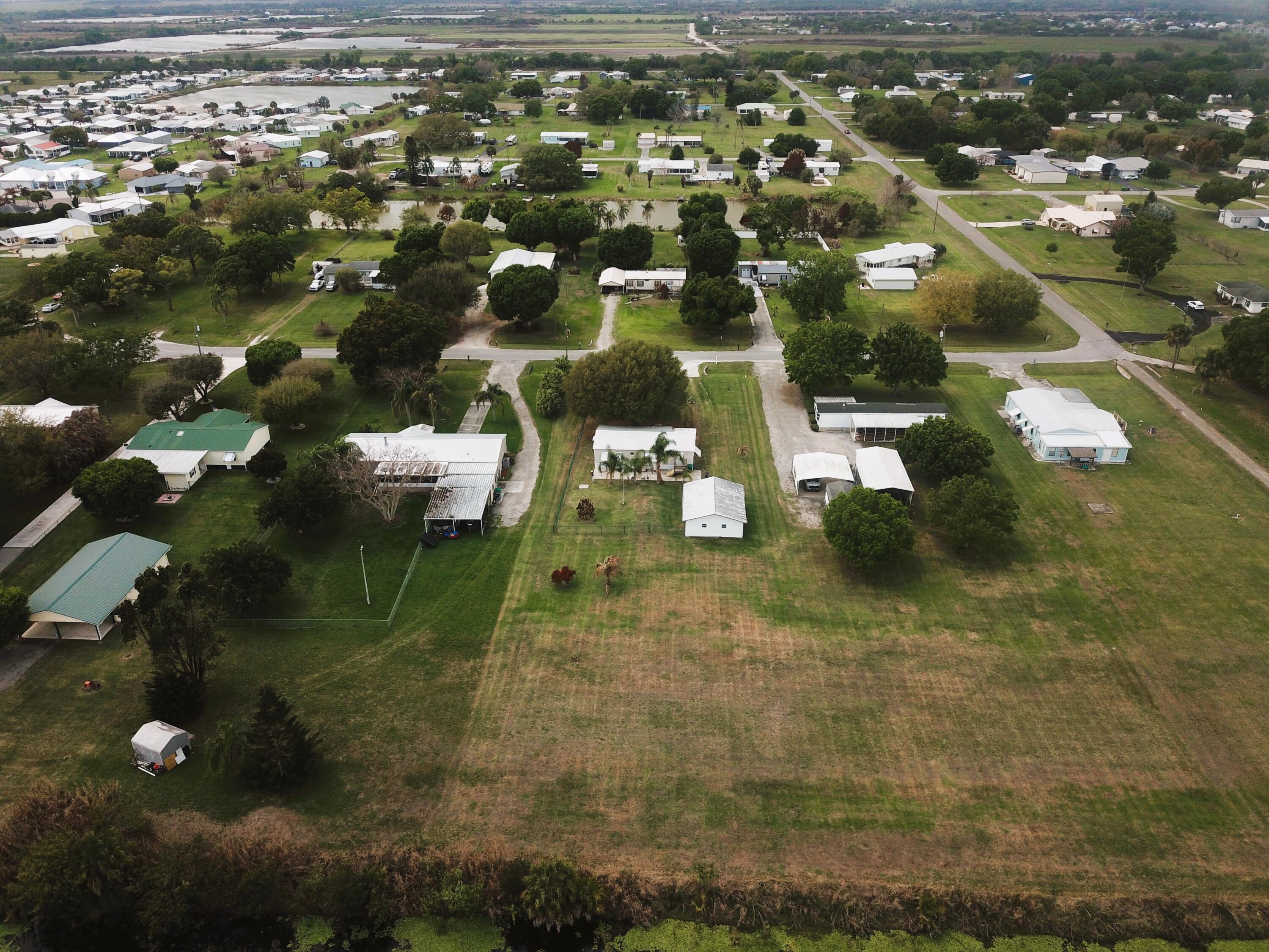 4064 Southwest 9th Way Okeechobee, FL 34974 - Photo 32 of 39 an aerial view of residential houses with outdoor space