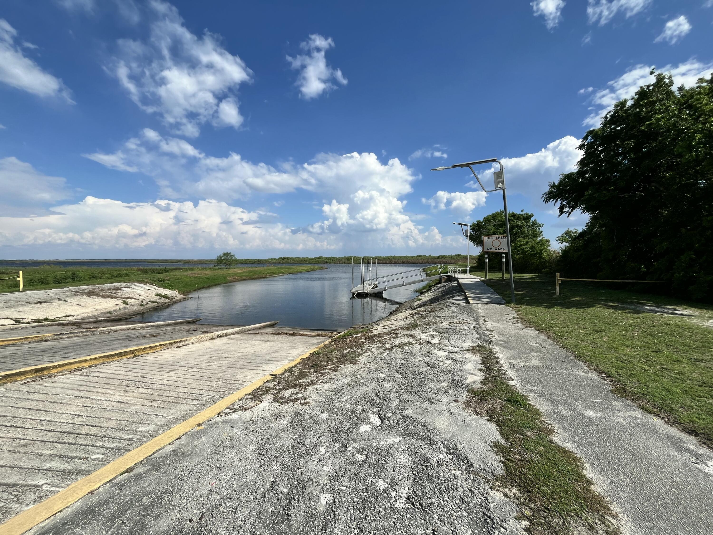 4064 Southwest 9th Way Okeechobee, FL 34974 - Photo 37 of 39 a view of a lake with a yard