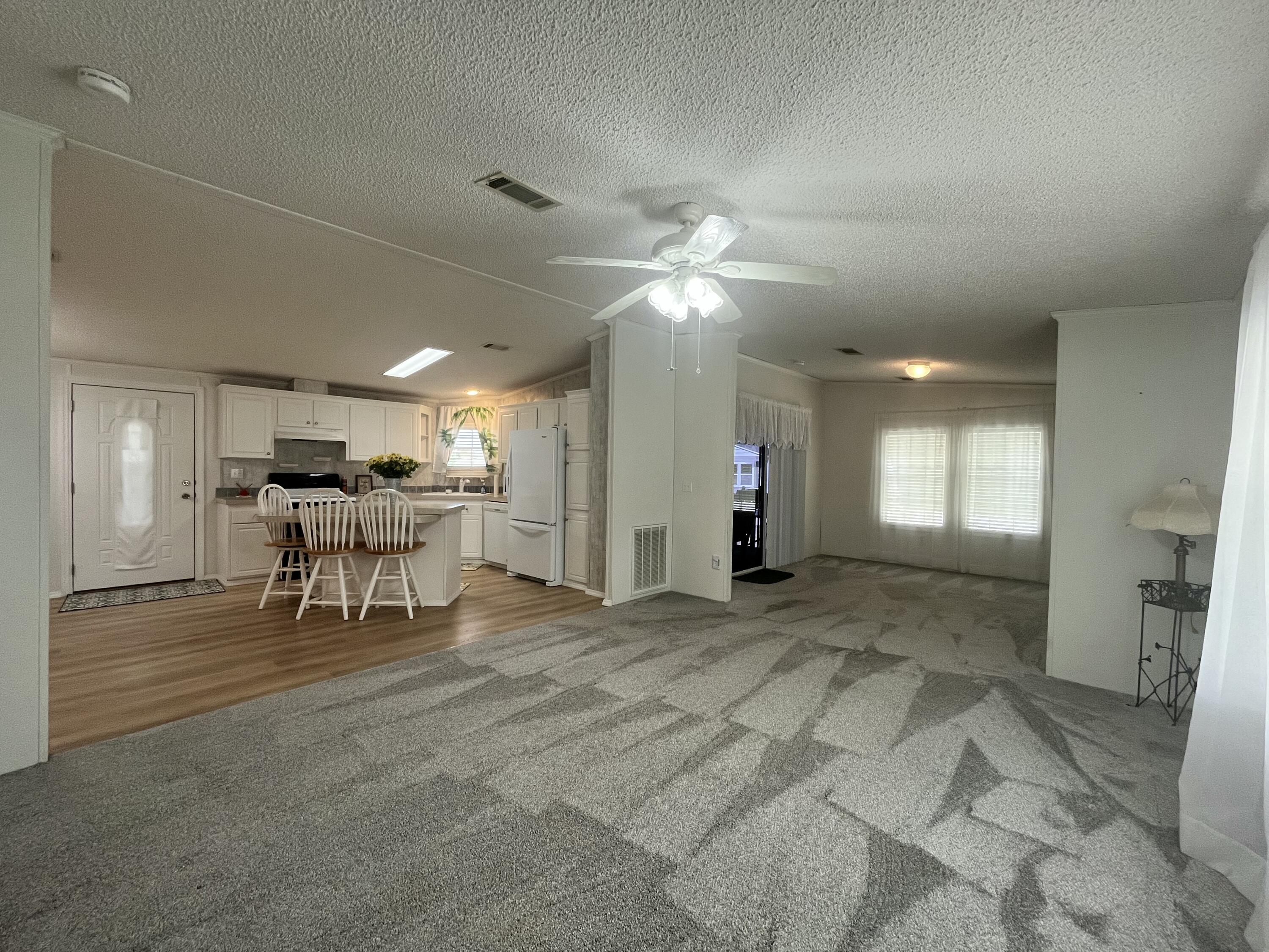 4064 Southwest 9th Way Okeechobee, FL 34974 - Photo 7 of 39 a view of a livingroom with furniture and a table chairs