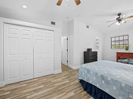 a large bedroom with a bed and a chandelier