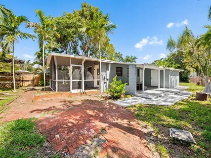 a view of a house with a yard and tree