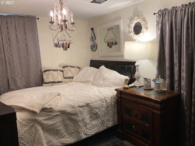 1420 Southwest Goodwin Place Pendleton, OR 97801 - Photo 19 of 27 a bedroom with a bed and a table in it