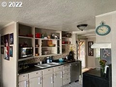 1420 Southwest Goodwin Place Pendleton, OR 97801 - Photo 10 of 27 a kitchen with a clock and cabinets