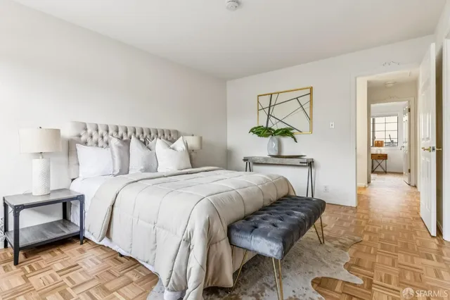 a bedroom with a bed and a chandelier