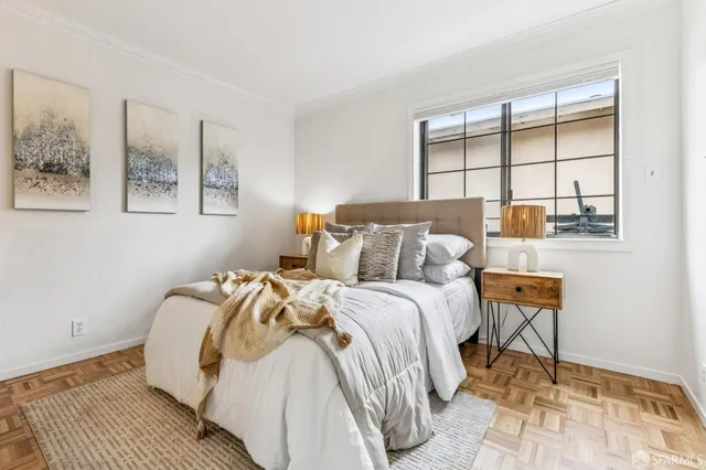 a bed sitting in a bedroom next to a window