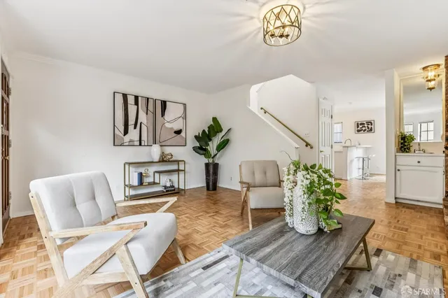 a living room with furniture and a chandelier