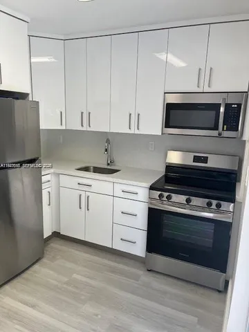 a kitchen with a stove and a microwave