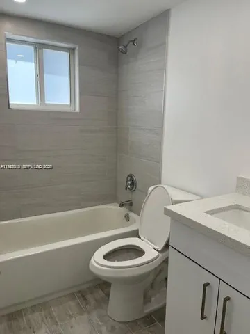 a bathroom with a toilet a sink and bathtub