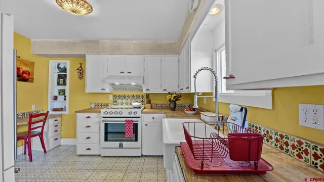 a kitchen with a stove and a refrigerator