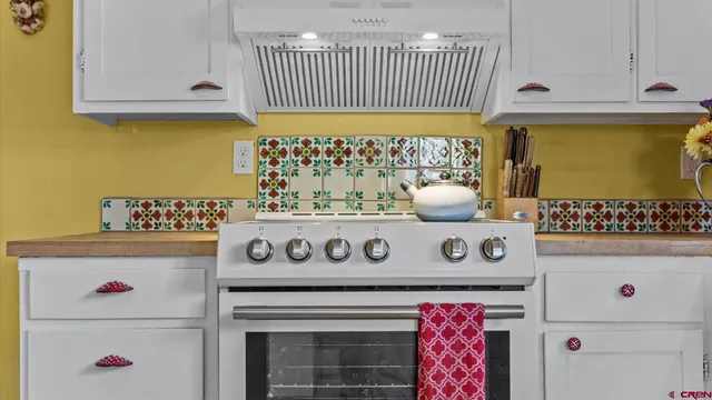 a open kitchen with stainless steel appliances granite countertop a stove and a cabinets