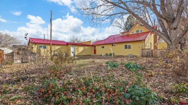 a living room filled with furniture hardwood floor and a chandelier
