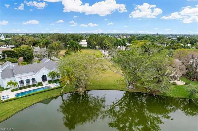 a view of residential houses with outdoor space and a lake view