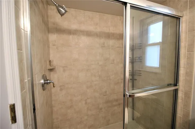 a bathroom with a glass shower door