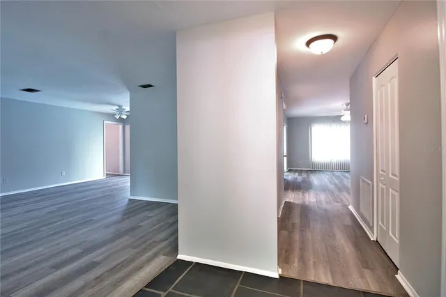 a view of hallway with wooden floor