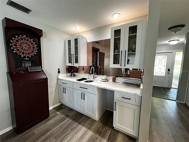 a kitchen with a sink stove and cabinets