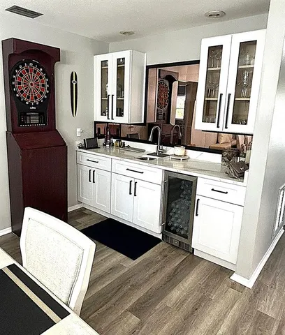 a hallway with sink wooden cabinets and furniture