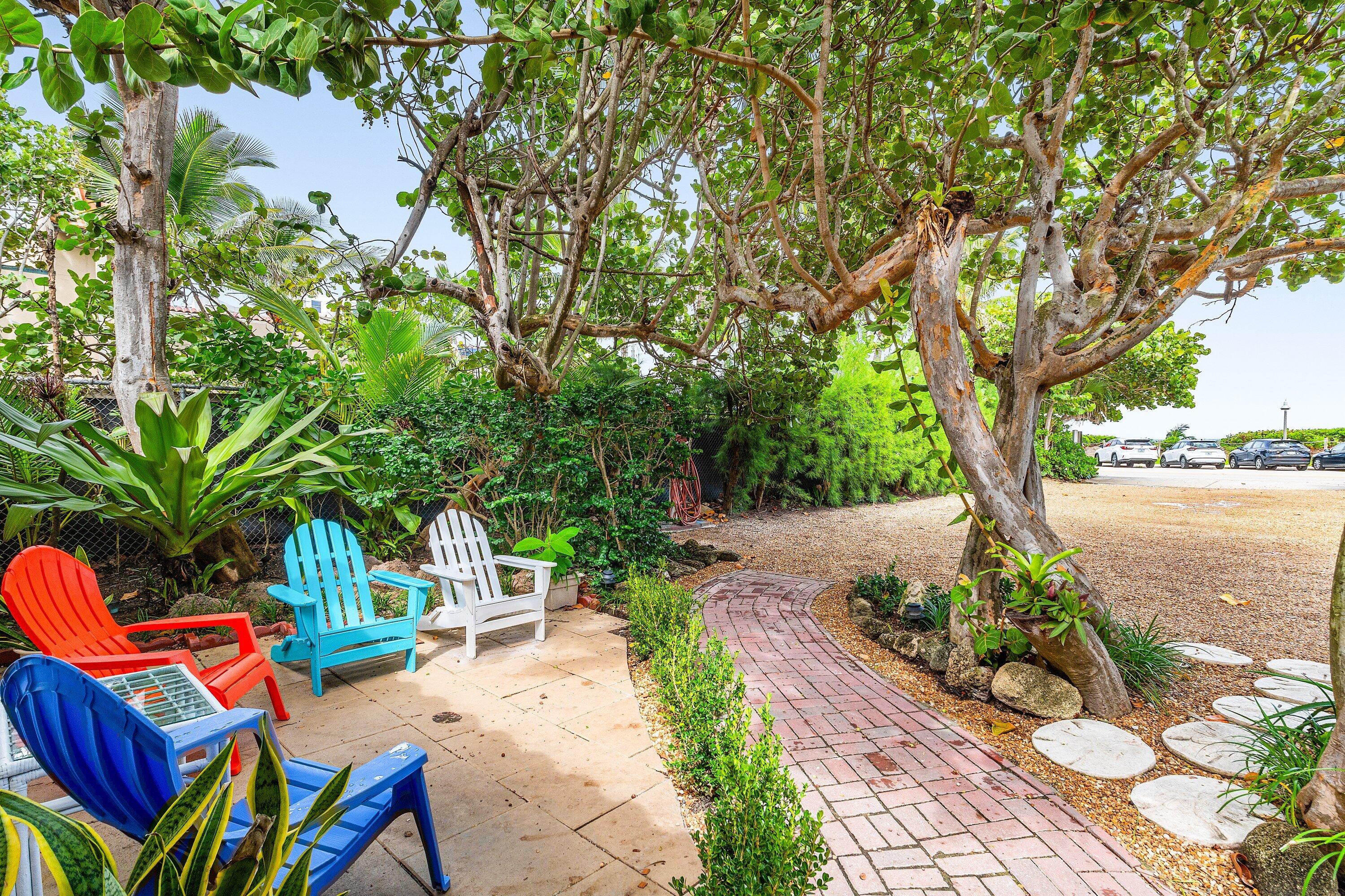 72 South Ocean Boulevard, Unit 1 Delray Beach, FL 33483 - Photo 19 of 35 a backyard of a house with seating space