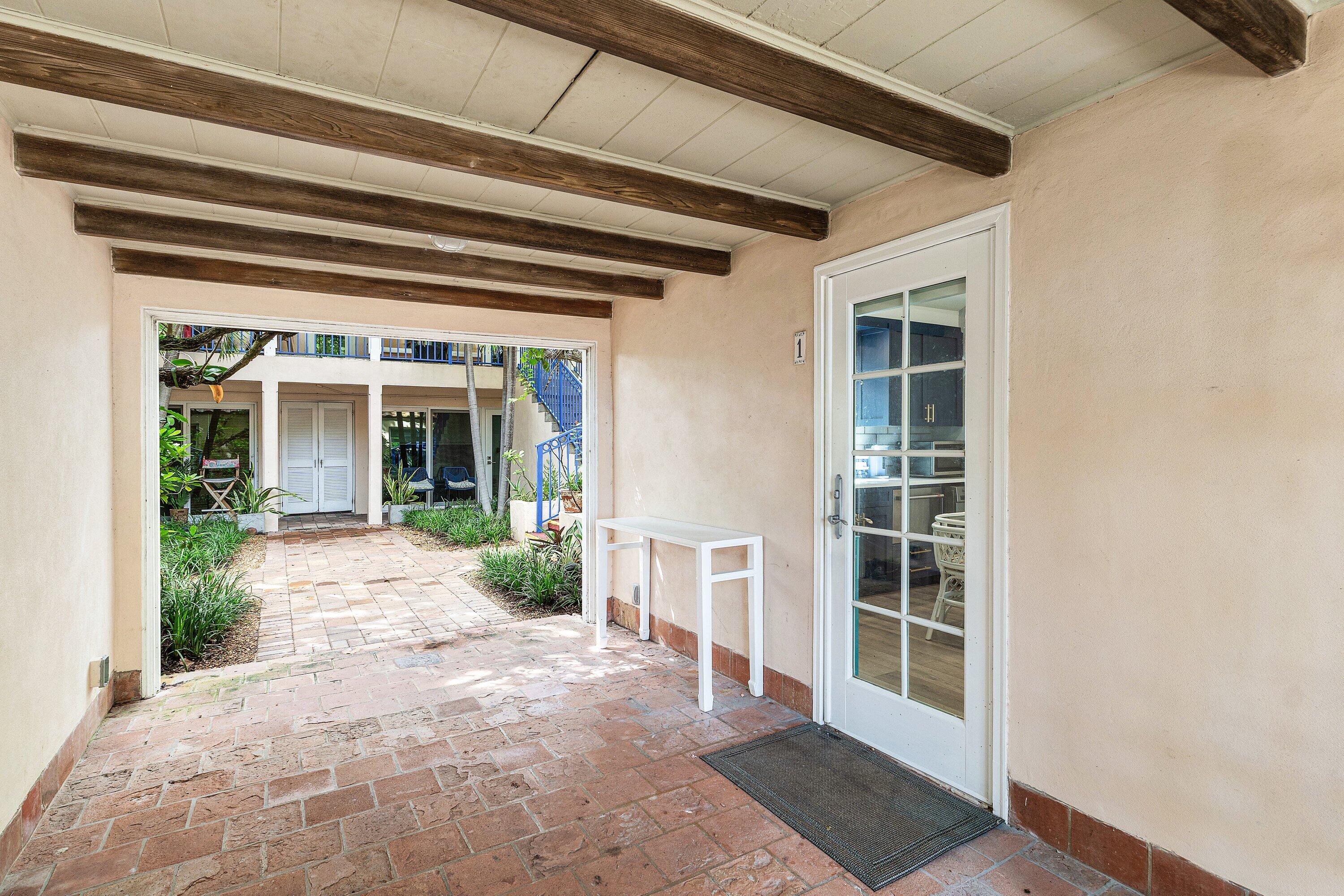 72 South Ocean Boulevard, Unit 1 Delray Beach, FL 33483 - Photo 3 of 35 a view of a house with a large window and plants