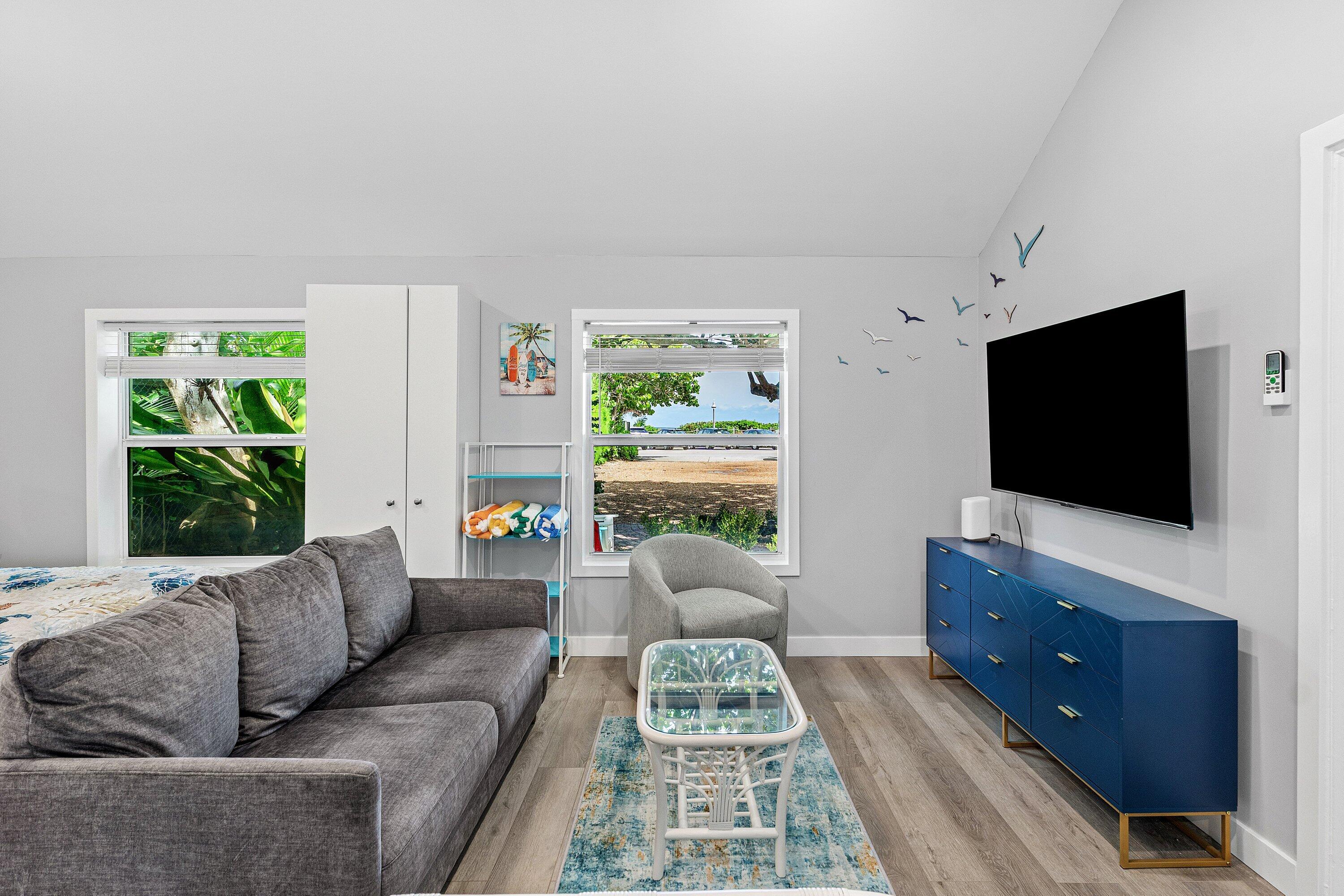 72 South Ocean Boulevard, Unit 1 Delray Beach, FL 33483 - Photo 8 of 35 a living room with furniture and a flat screen tv