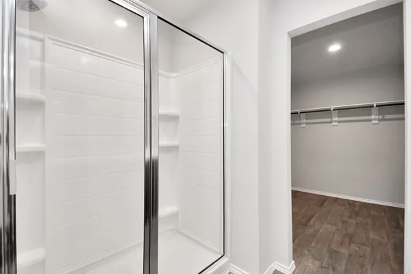 a en suite bathroom with a granite countertop sink toilet a mirror and shower