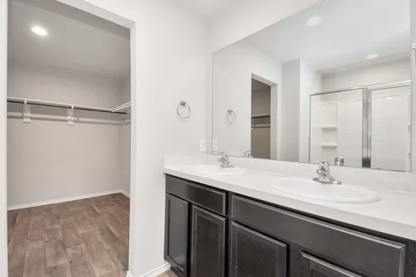 a bathroom with a sink a mirror and a shower