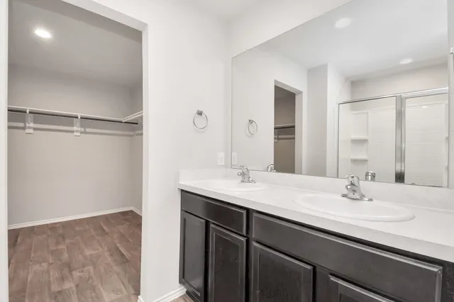 a bathroom with a sink a mirror and a shower