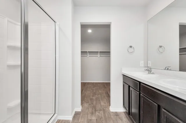a bathroom with a shower and a glass door