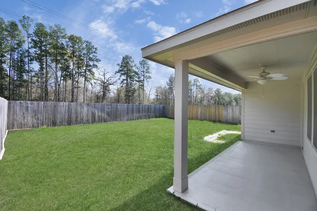 a kitchen with a sink a refrigerator and wooden cabinets