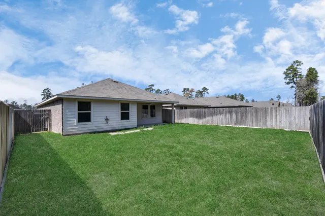 a kitchen with granite countertop kitchen island stainless steel appliances a sink stove and cabinets