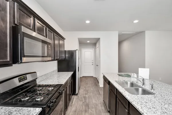 a view of a kitchen with a sink and a refrigerator